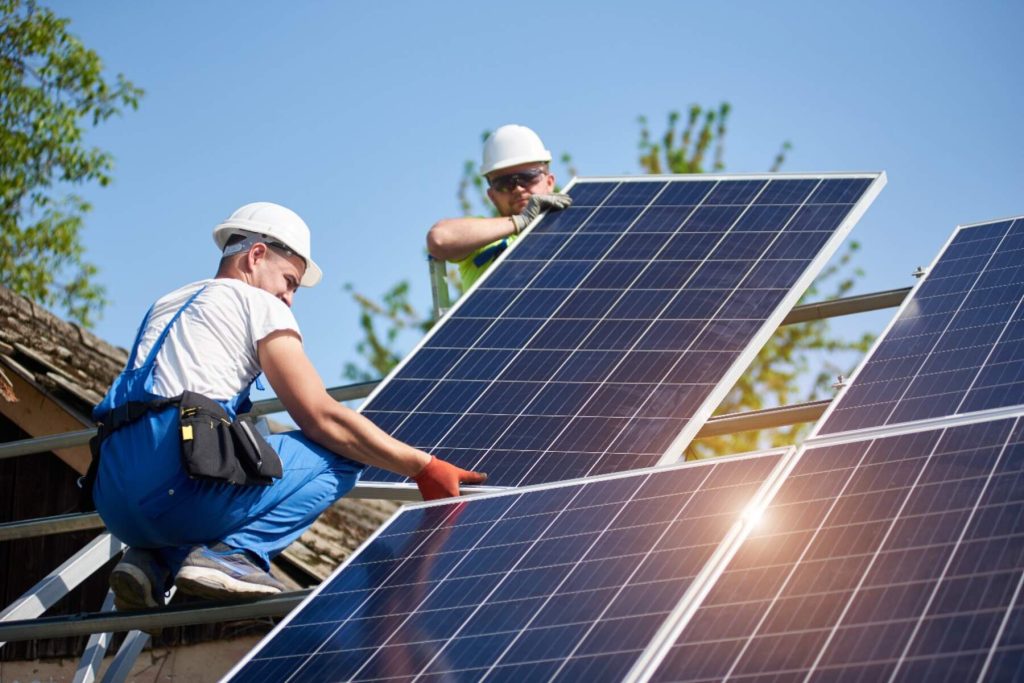 Electricians in New York installing solar panels